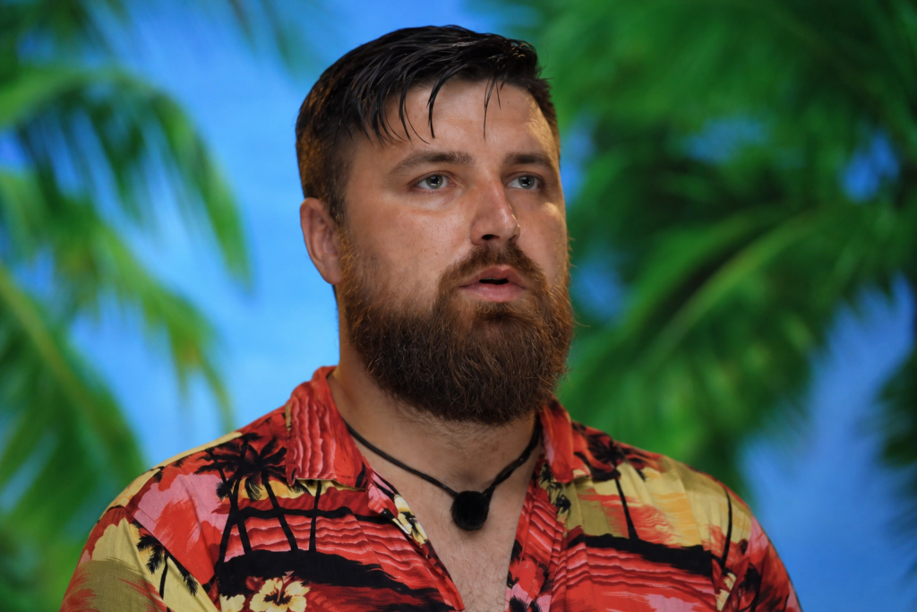 A portrait of a bearded man in a Hawaiian shirt with promotional text and tropical background